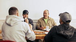 A group of friends enjoy pizza at an eatery