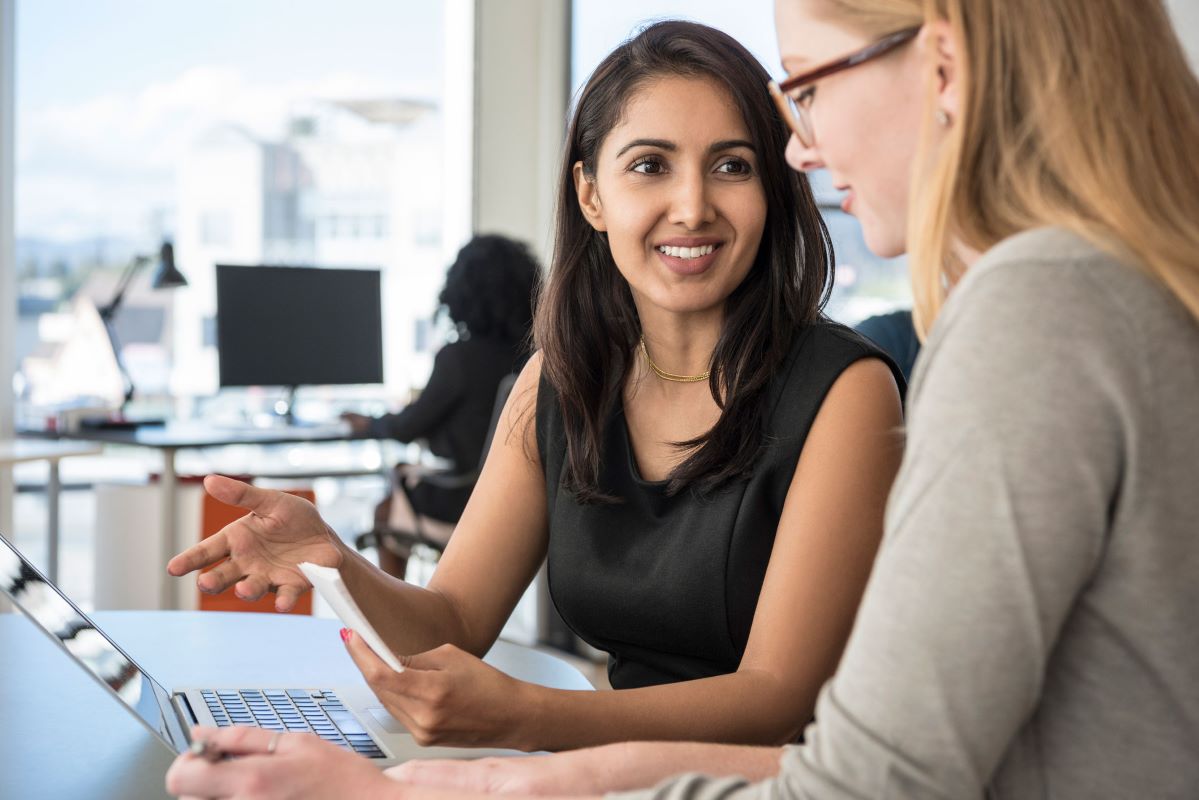 Workplace with two women chatting