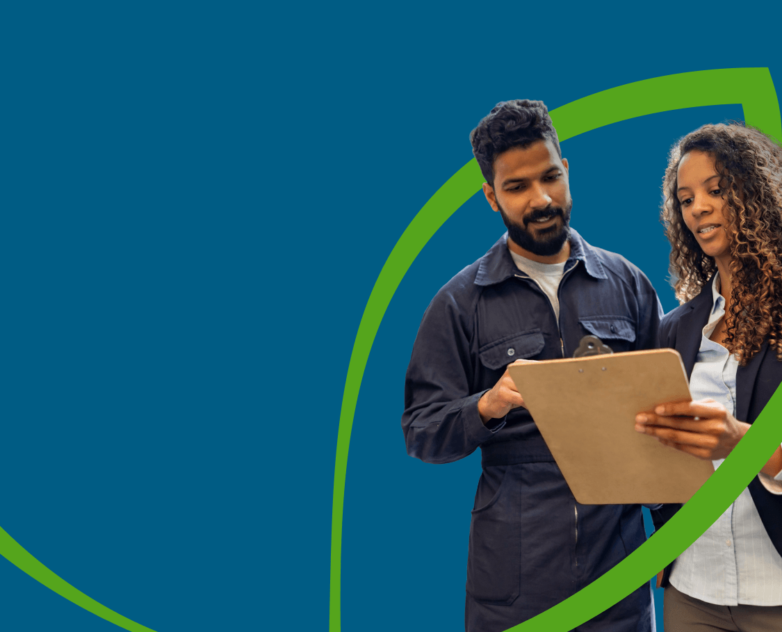 Two coworkers having a discussion while looking at a clipboard, with a green line forming the shape of a leaf around them.
